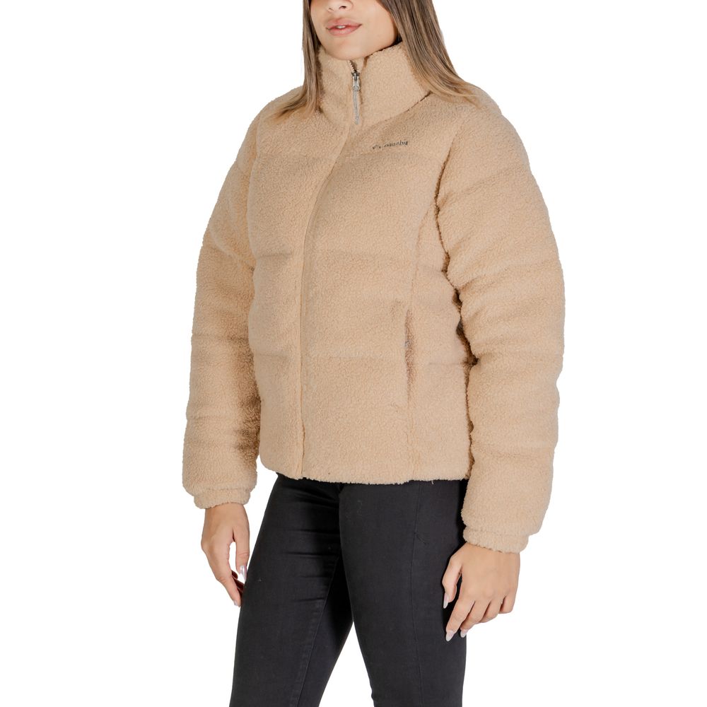 Woman wearing Columbia Beige Nylon Coat with Sherpa lining, perfect for cold weather outings and stylish comfort.