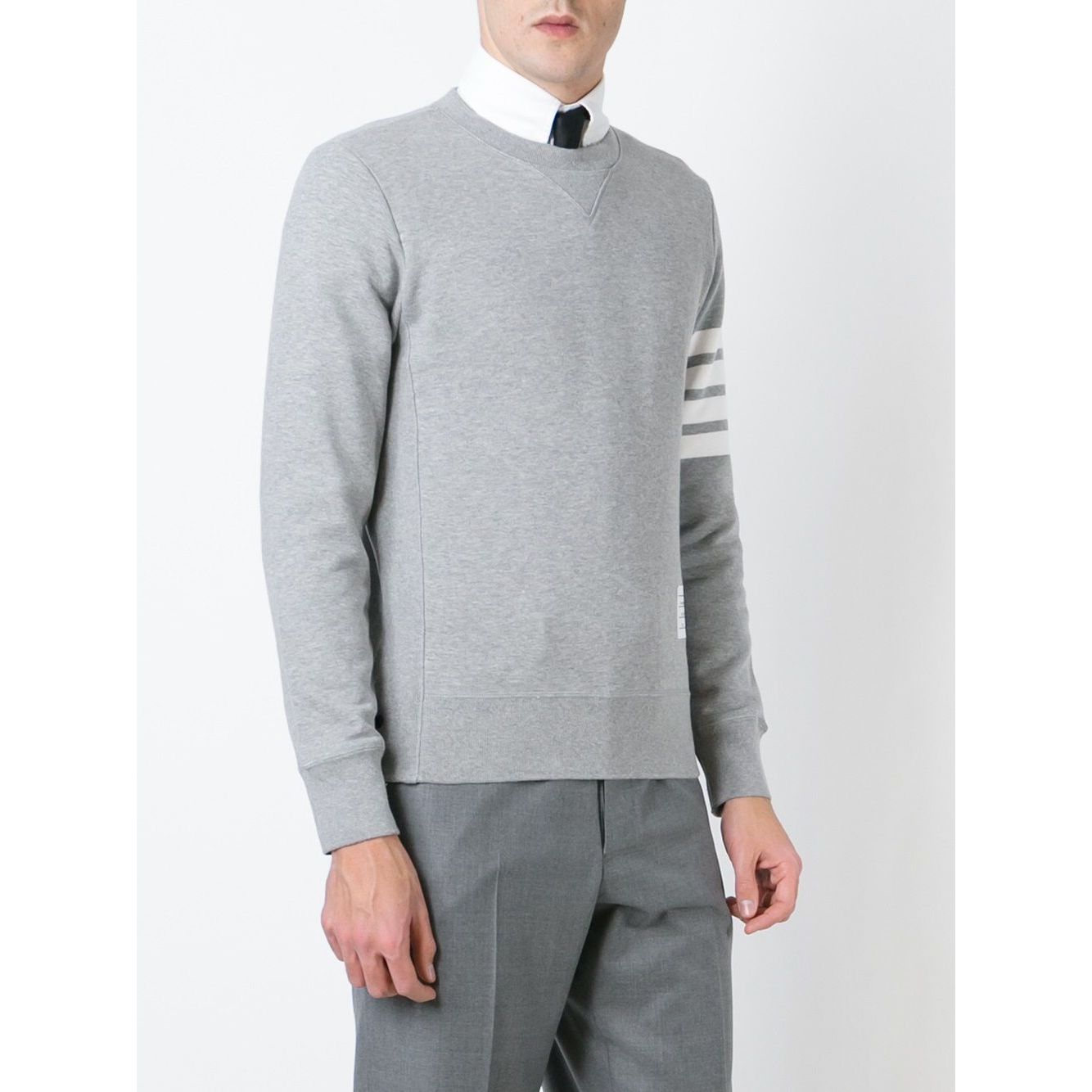 Model wearing Thom Browne Sweaters Grey featuring 4-Bar stripe, V insert crew neck, ribbed trims, and button side fastening.
