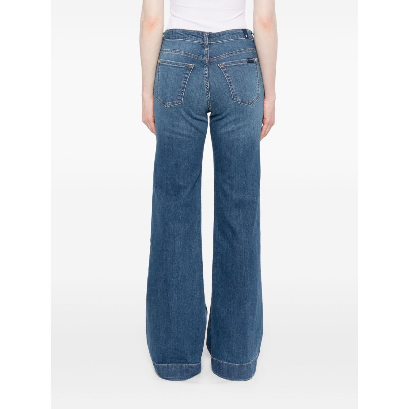 Back view of Seven Jeans Blue wide-leg denim with belt loops, slash and patch pockets, showcased on a model. Fashionable and versatile.