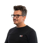 Man wearing Ermenegildo Zegna Black Men Glasses Frame with black plastic full-rim rectangular design and spring hinges.