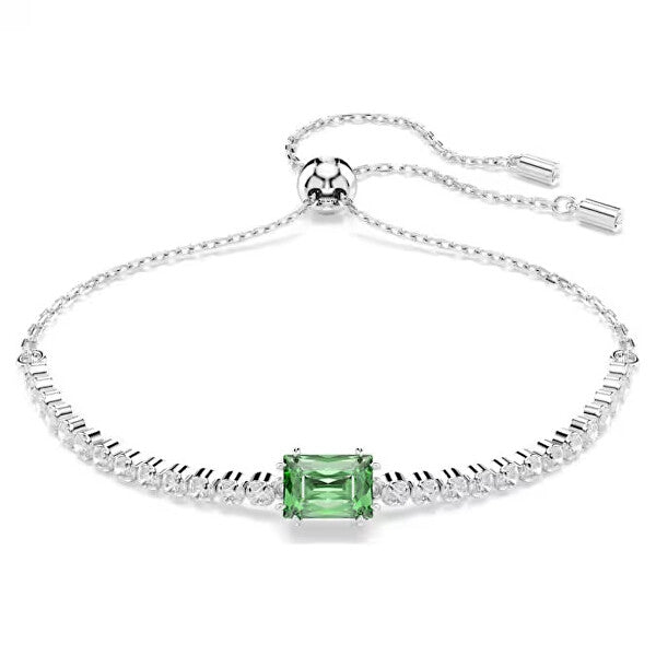 Elegant silver bracelet with central green gemstone, ideal for formal occasions.