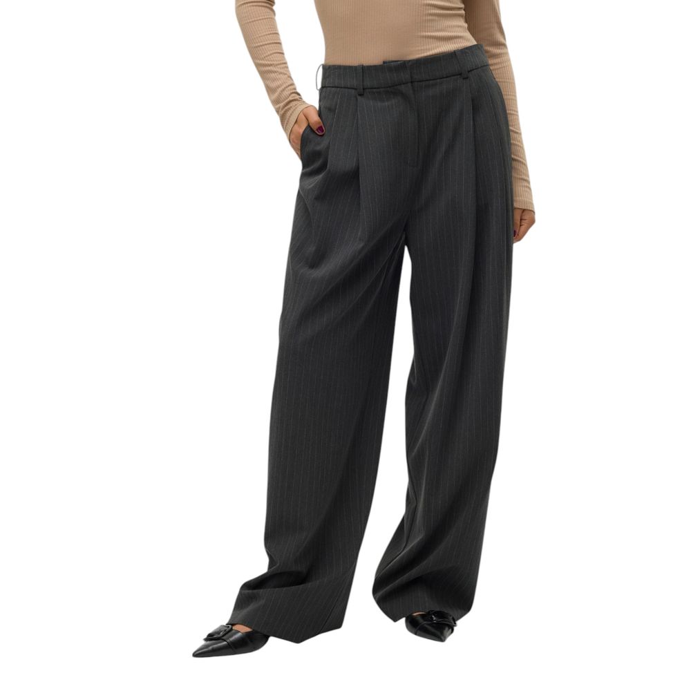 Woman wearing Vero Moda gray pinstripe wide-leg palazzo pants, polyester blend, featuring a sophisticated and modern design.