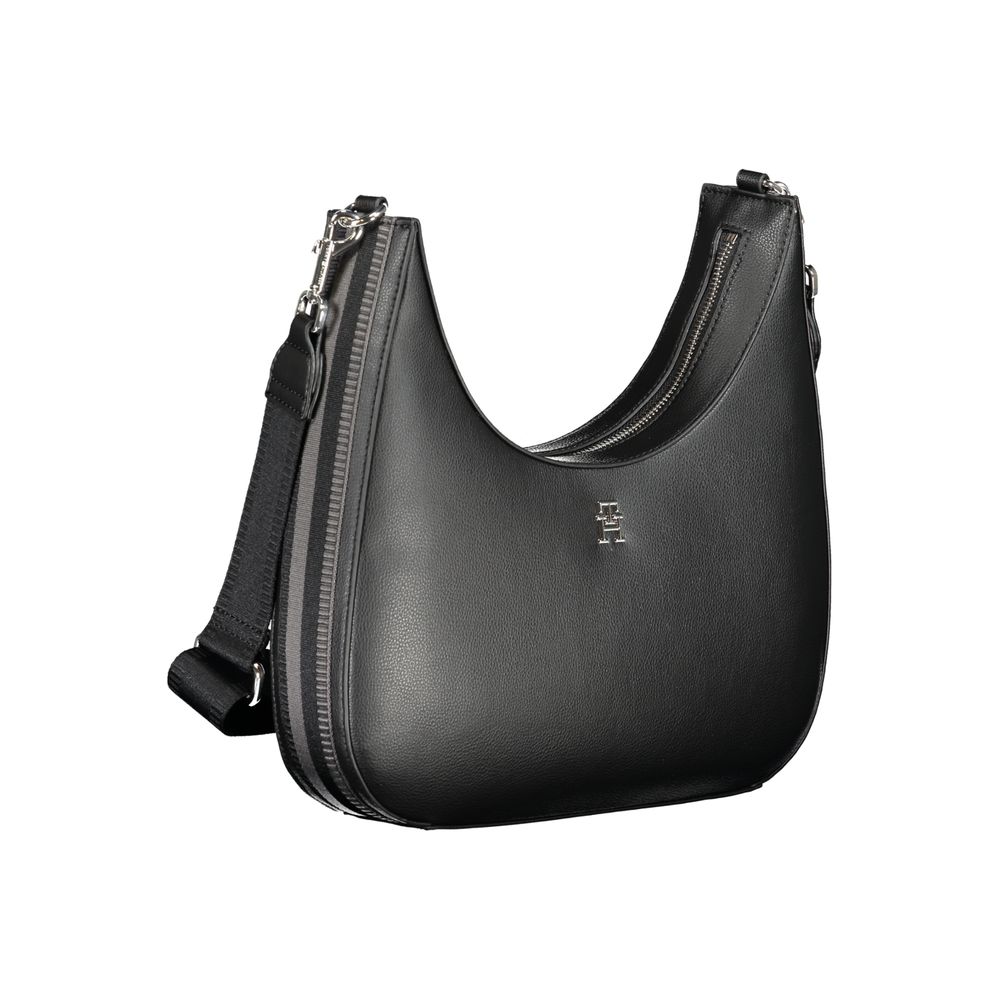 Tommy Hilfiger Black Polyester Handbag with adjustable shoulder strap, internal pocket, logo, contrasting details, and zip closure.