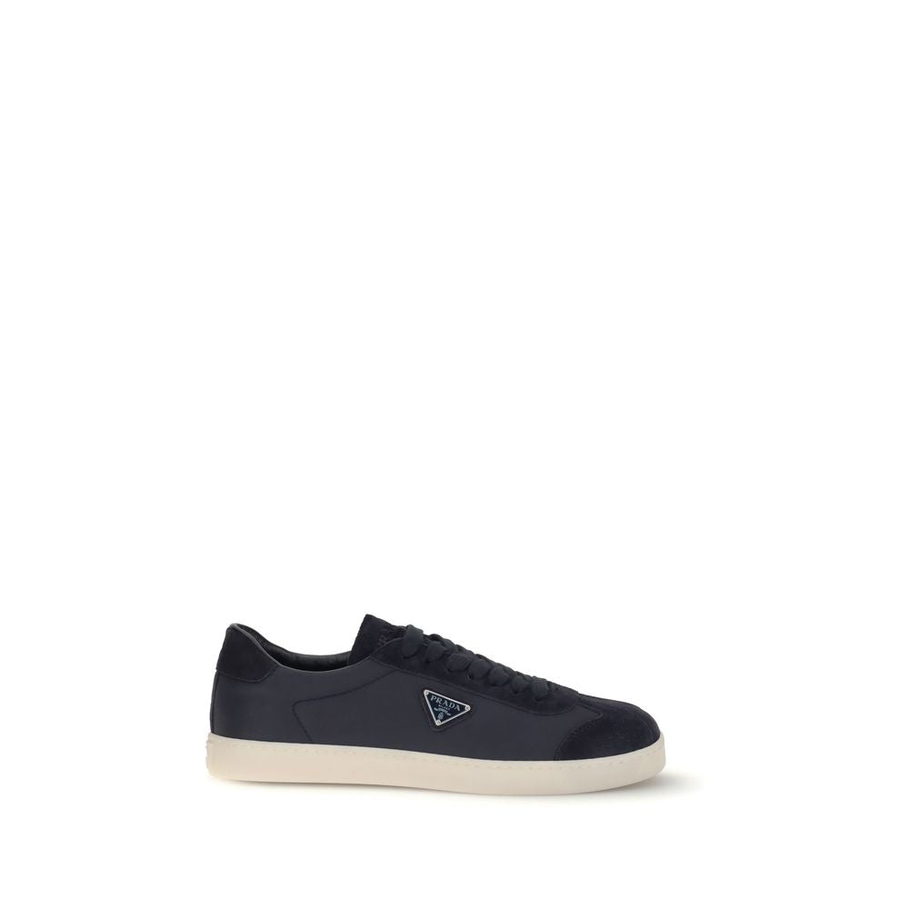 Prada Leather Sneakers with rubber sole, iconic triangular side plaque, round toe, and tone-on-tone logo. Made in Italy, AW25.