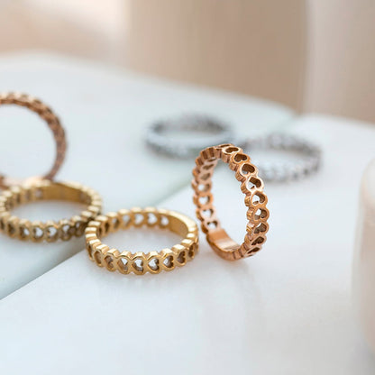 AN JEWELS JEWELRY Mod. AL.RSC01SYR-9 featuring gold and rose gold intricate rings on a marble surface.