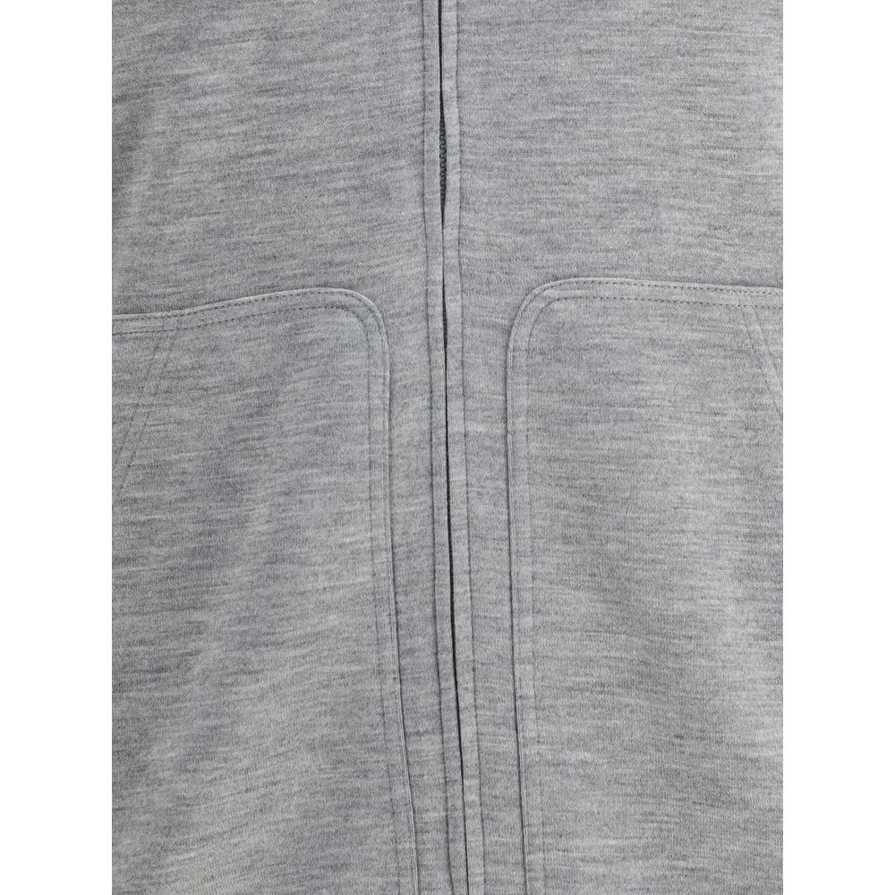 Close-up of Brunello Cucinelli Gray Cashmere Sweatshirt showing patch welt pockets and monochrome design.