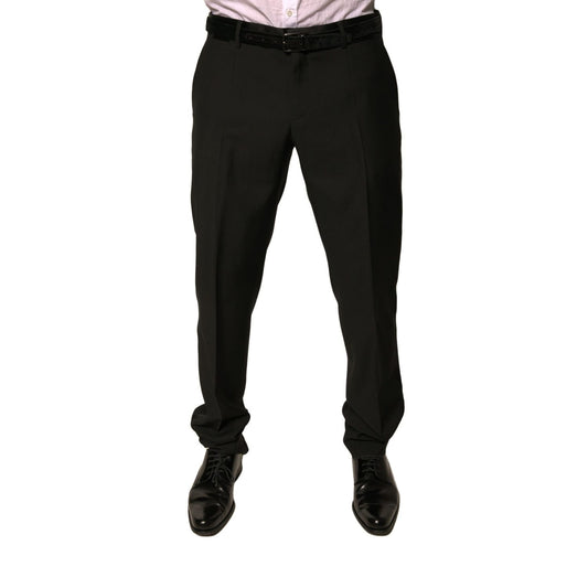 Model wearing Dolce & Gabbana Black Wool Tapered Formal Dress Pants with button and zipper closure; high craftsmanship and luxurious design.