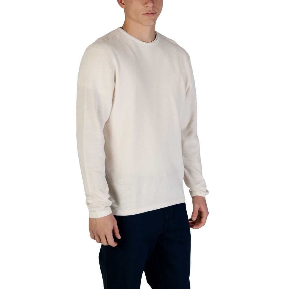 Man wearing Jack Jones White Cotton Sweatshirt with crew neck and fine knit texture, showcasing a versatile and sustainable clothing item.