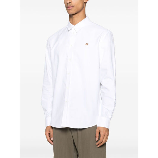 Maison Kitsuné Maison Kitsune classic shirt wth fox head logo in white cotton with button closure, worn by model, front view, classic collar.