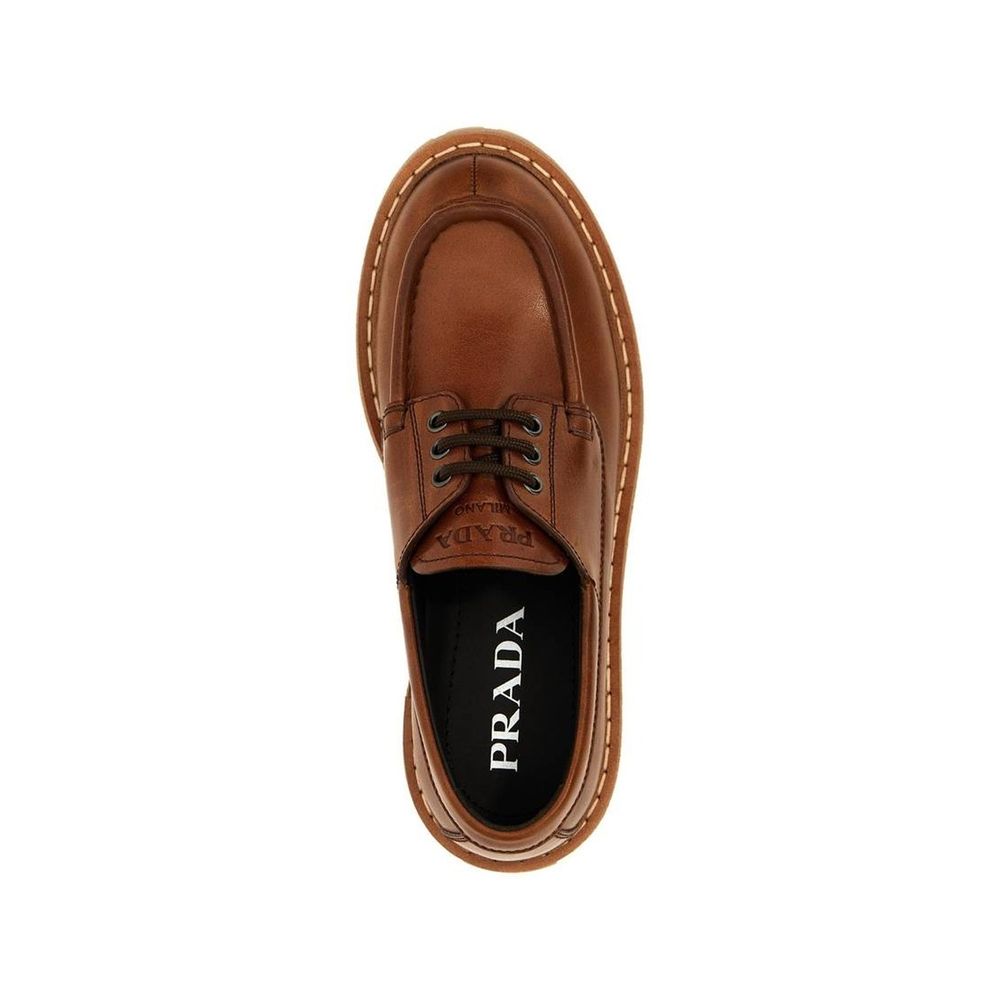Top view of Prada St. Moritz Derby Loafers in brown calf leather with lace-up closure and logo detail, women's footwear.