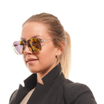 Lady wearing SWAROVSKI MOD. SK0379-H 5932G sunglasses with reflective lenses.