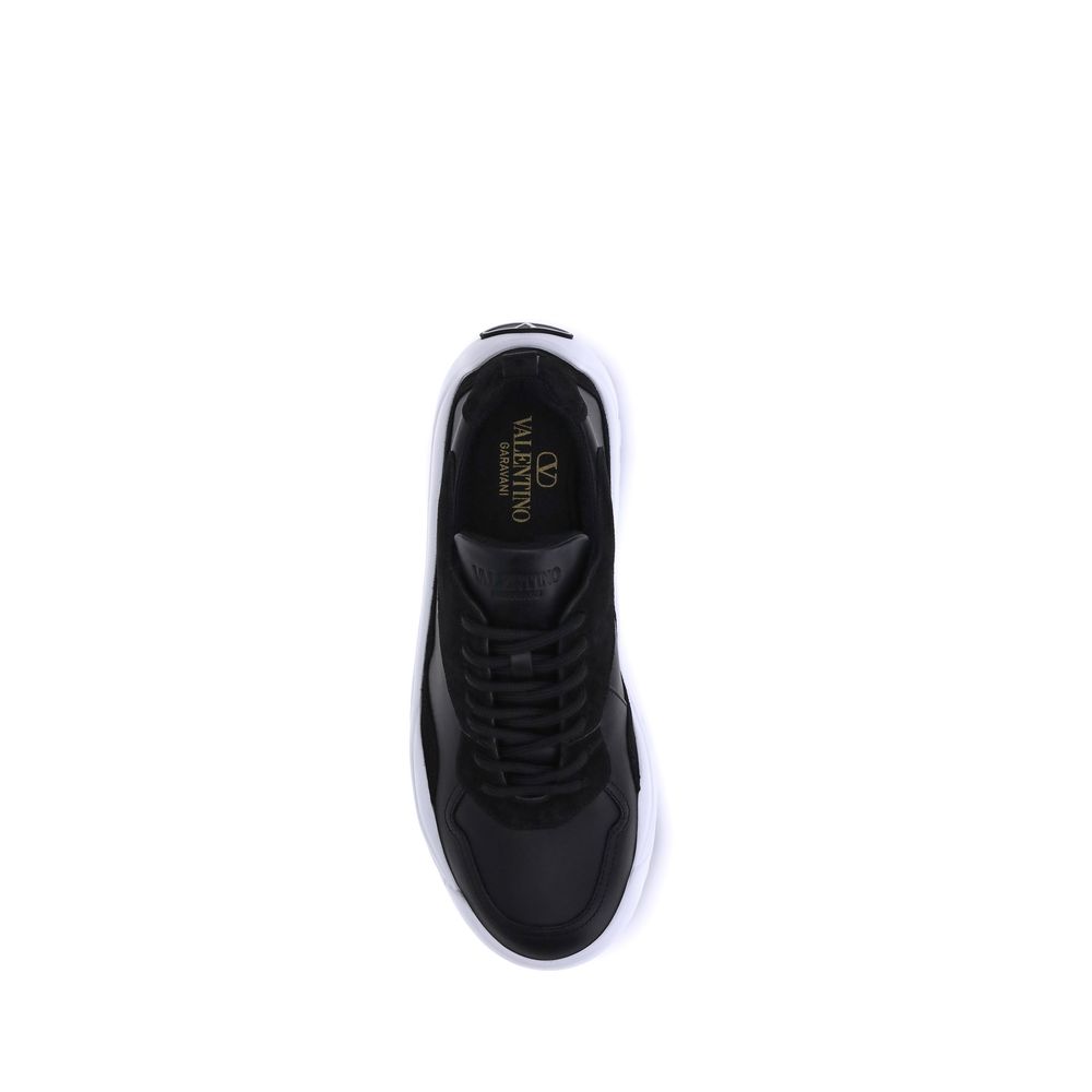 Top view of Valentino Garavani Black Calf Leather Bos Taurus Chunky Sneakers showing lace-up design and embossed logo on tongue.