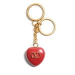 Valentino Garavani Coeur Royal key ring with red charm and logo on gold attachment, polished finish, 13 cm length, 3.5 cm width.