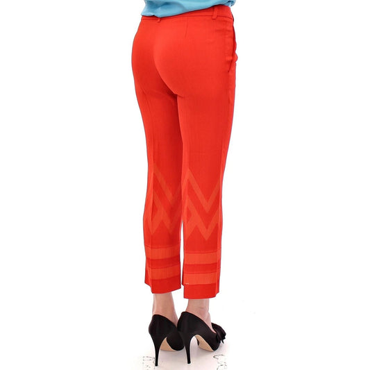 Model wearing Versace Collection Red Pants Cropped 3/4 Short Nude Capri Pants with unique leg pattern, rear view.